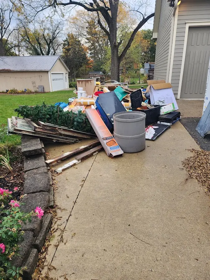 Dumpster being loaded with debris for Residential Dumpster Rental in Kyle